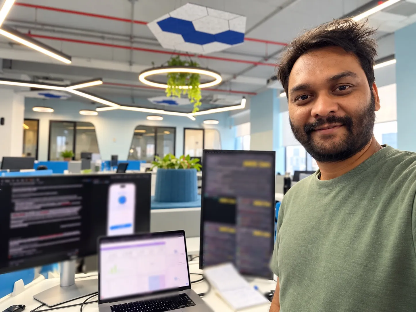 Kumar Gaurav at his hackathon desk at Cowbell, with the voice-enabled OMNI agents running on a phone and monitors